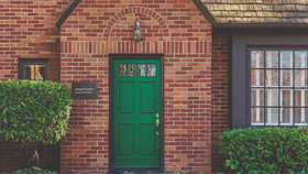 Front door (PMQ) with green foliage