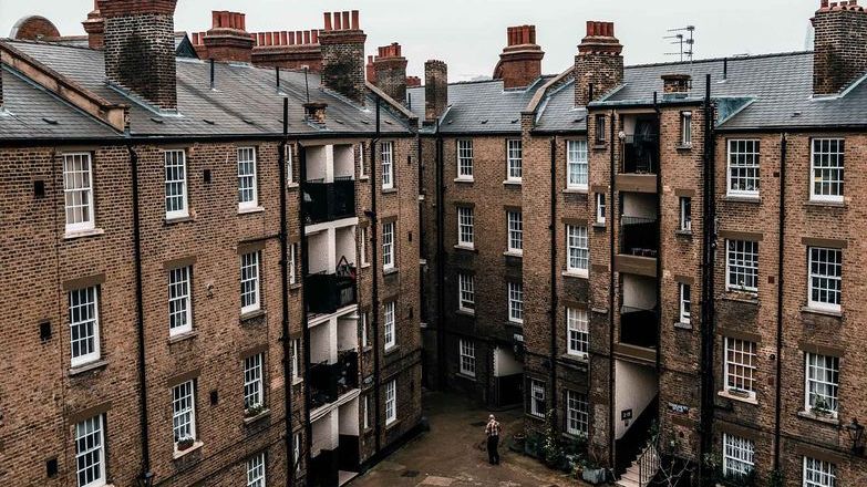 Person standing near apartment blocks in London