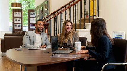 Couple talking to agent in branch