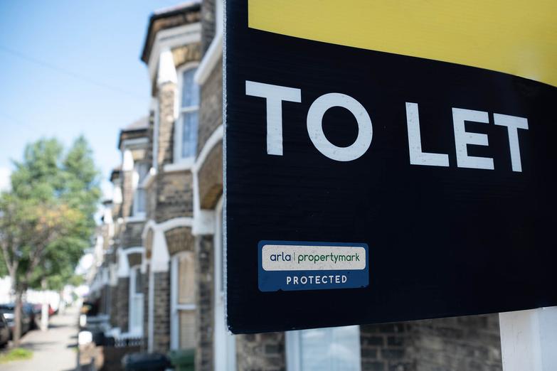 To let board sign with street in background