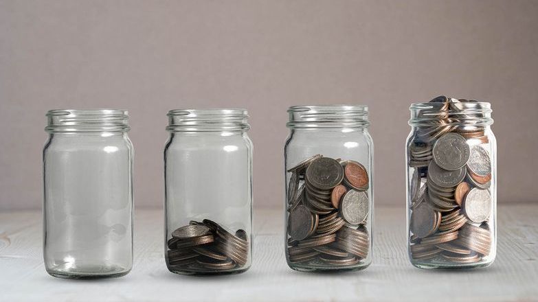 Coins in jars moving from empty to full jars