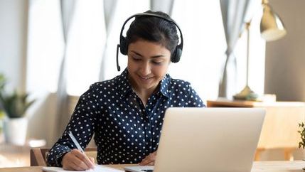 Woman studying with headset on