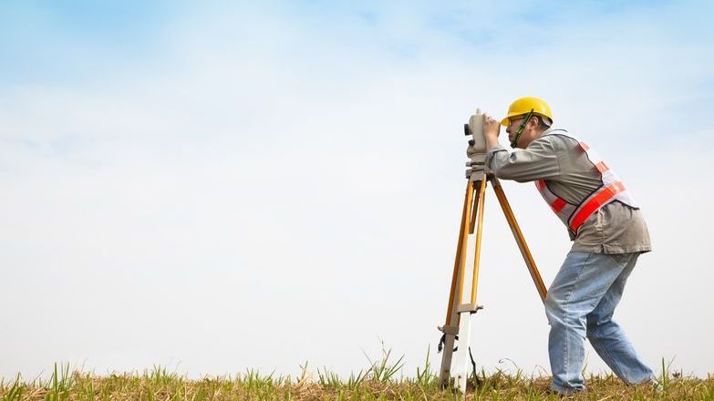 Surveyor in a field