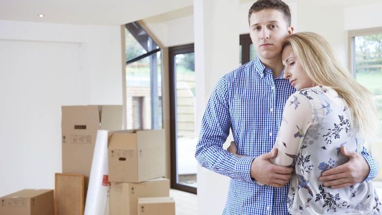 Unhappy couple with boxed up home