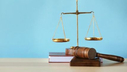 Legal gavel and scales on a desk