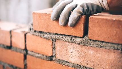 A bricklayer building a wall