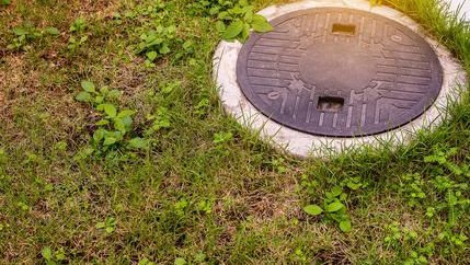 Septic tank cover on ground