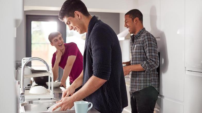 Housemates laughing in kitchen